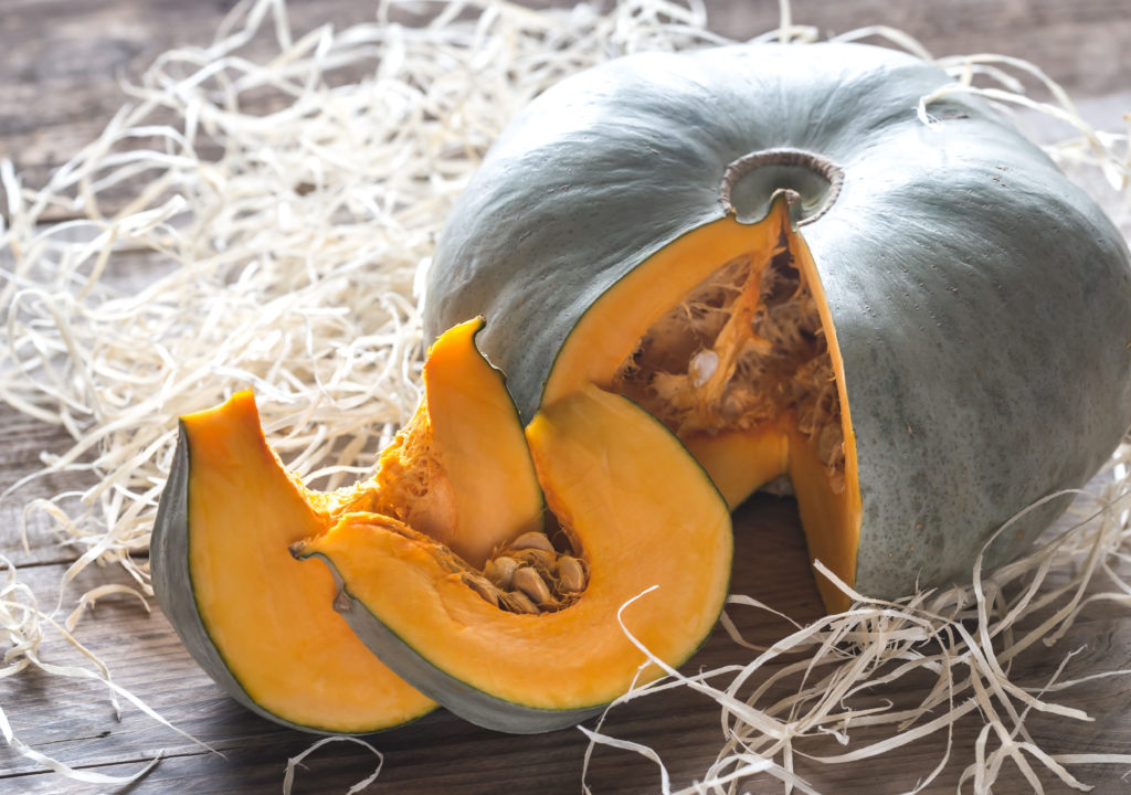 Ripe pumpkin on the wooden background